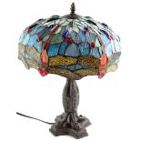 A Tiffany style lamp, the shade decorated with glass cabochon dragonflies etc., the bronzed base