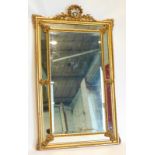 A continental gilt gesso wall or overmantel mirror, the moulded frame decorated with bell flower and