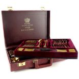 A Bestecke Solingen gold plated part canteen of cutlery, in a fitted leatherette case.