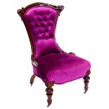 A Victorian mahogany show framed nursing chair, upholstered in vivid purple button velvet, on part