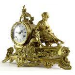 A continental brass figural mantel clock, the dial with Roman numerals, 38cm wide.