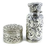 An embossed silver scent bottle, with glass liner, the lid (AF), marks indistinct and a