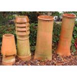 Three large teracotta chimney pots, of differing designs, the smaller example, etc., 92cm, 89cm,