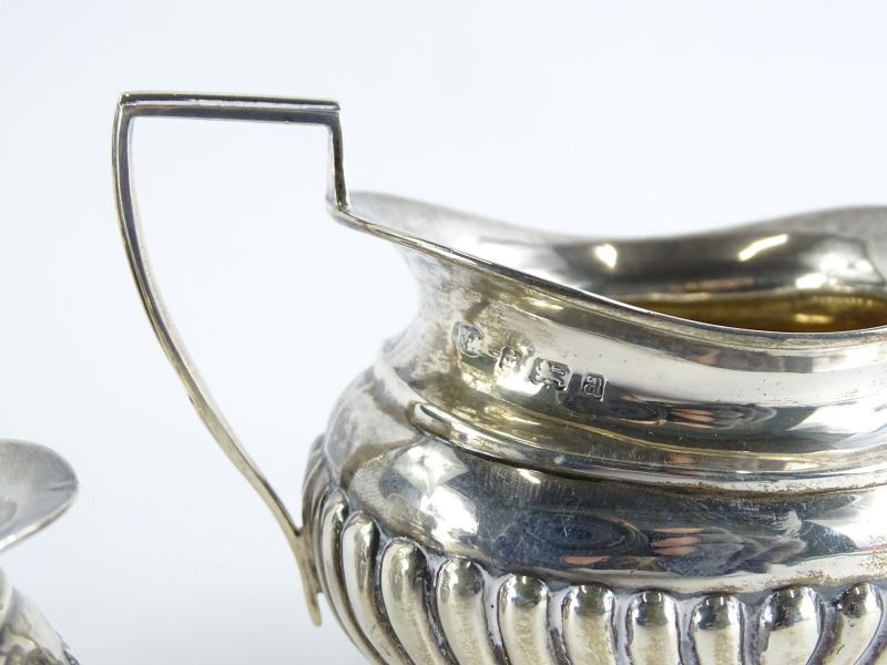 An Edwardian silver two handled sugar bowl, with part fluted decoration, Birmingham 1900, and a - Image 2 of 2