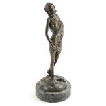 Nöel. A scantily clad lady, on a circular base with marble plinth, bronze, signed to base 32cm high.