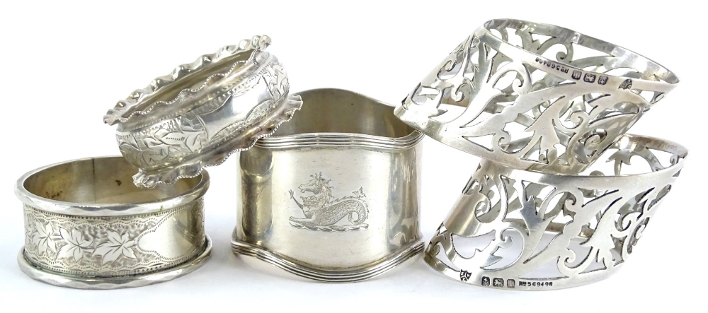 A collection of five early 20thC napkin rings, to include a pair with pierced borders, (AF), 3¼oz.