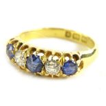 An 18ct gold sapphire and diamond gypsy ring, set with three cornflour blue sapphires and two