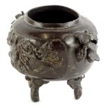 A Chinese bronze koro, cast with birds, flowers etc., on tapering feet (AF), 14cm wide, 10cm high.