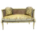 A Regency bergere sofa, painted in cream and powder blue, the frame carved with acanthus, fans and