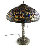 A Tiffany style lamp, the leaded shade decorated with glass cabochon dragonflies etc., on a