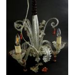 A Venetian type glass three branch chandelier, decorated with scrolls, gilt and red glass