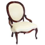 A Victorian mahogany showframed nursing chair, with a padded back and seat upholstered in gold