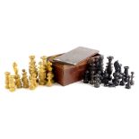 A turned wooden chess set, part stained black, in fitted box, the largest piece 9cm high.