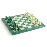 An onyx and white alabaster chess set and board, 29cm square.