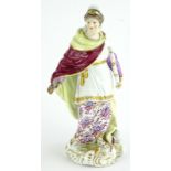 A 19thC continental porcelain figure, modelled in the form of a lady with a knife and a scroll,