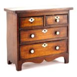 A 19thC miniature mahogany chest of drawers, with two short and three long drawers, each with bone
