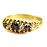 An 18ct gold sapphire and diamond gypsy ring, set with three round cut sapphires and two diamonds,