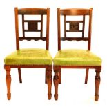 A pair of late 19thC mahogany side chairs, each with a carved central tablet initialled GNR for