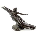 An Art Nouveau style bronze figure of a female nude in a reclining pose, on a circular base,