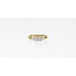 An 18ct gold diamond trilogy ring, with three princess cut diamonds, the centre stone 4.2mm x 4mm