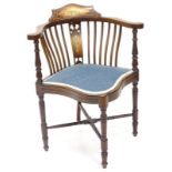 An Edwardian mahogany and marquetry corner chair, with a blue upholstered padded seat, on turned