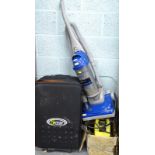 A Vax Astrat 1800W upright vacuum cleaner, jet washer and a suitcase.