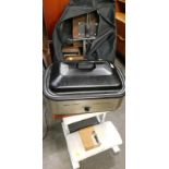 A folding electric massage chair, a set of padded steps, a hot stone heater with stones etc.
