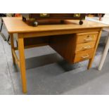 A lightwood desk, of rectangular form with three drawers, on square tapering legs joined by a H
