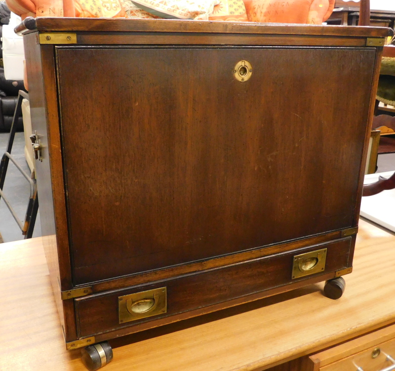 *A stained 20thC campaign style cabinet of rectangular form, with side carrying handles, flush front