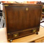 *A stained 20thC campaign style cabinet of rectangular form, with side carrying handles, flush front