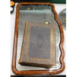 A rectangular wall mirror, the frame decorated to simulate wood and a Bible printed by William