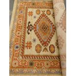 A HMC Cashmere Range cream ground carpet, decorated in Persian style with medallions etc., 200cm x