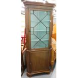 A mahogany standing corner cabinet, with single glazed door above a panelled door.