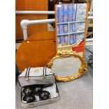 A gilt gesso wall mirror, a teak framed mirror, an oval mirror and a set of bowls.
