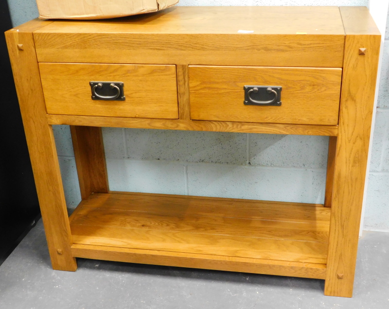 An oak two drawer side cabinet, with under tier.