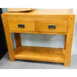 An oak two drawer side cabinet, with under tier.