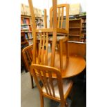 A Sakol furniture extending dining table and four chairs.