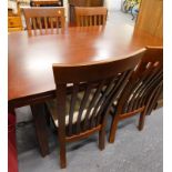 A rectangular topped dining table with four associated chairs.