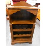A mahogany wine rack, with raised back and shelves for bottles etc.