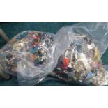 Two bags of miscellaneous costume jewellery, mainly beads to include bangles and necklaces.