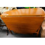 A modern teak dropleaf table, with cupboard to side.