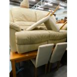 A cream leather two seater electric reclining settee, a white wood dining table, and three chairs,