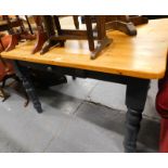 A pine kitchen table, with grey painted base.