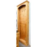An oversized pine bookcase, with fixed moulded cornice an open shelves, on a block base, 255cm high,