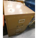 A brown painted two drawer metal filing cabinet.