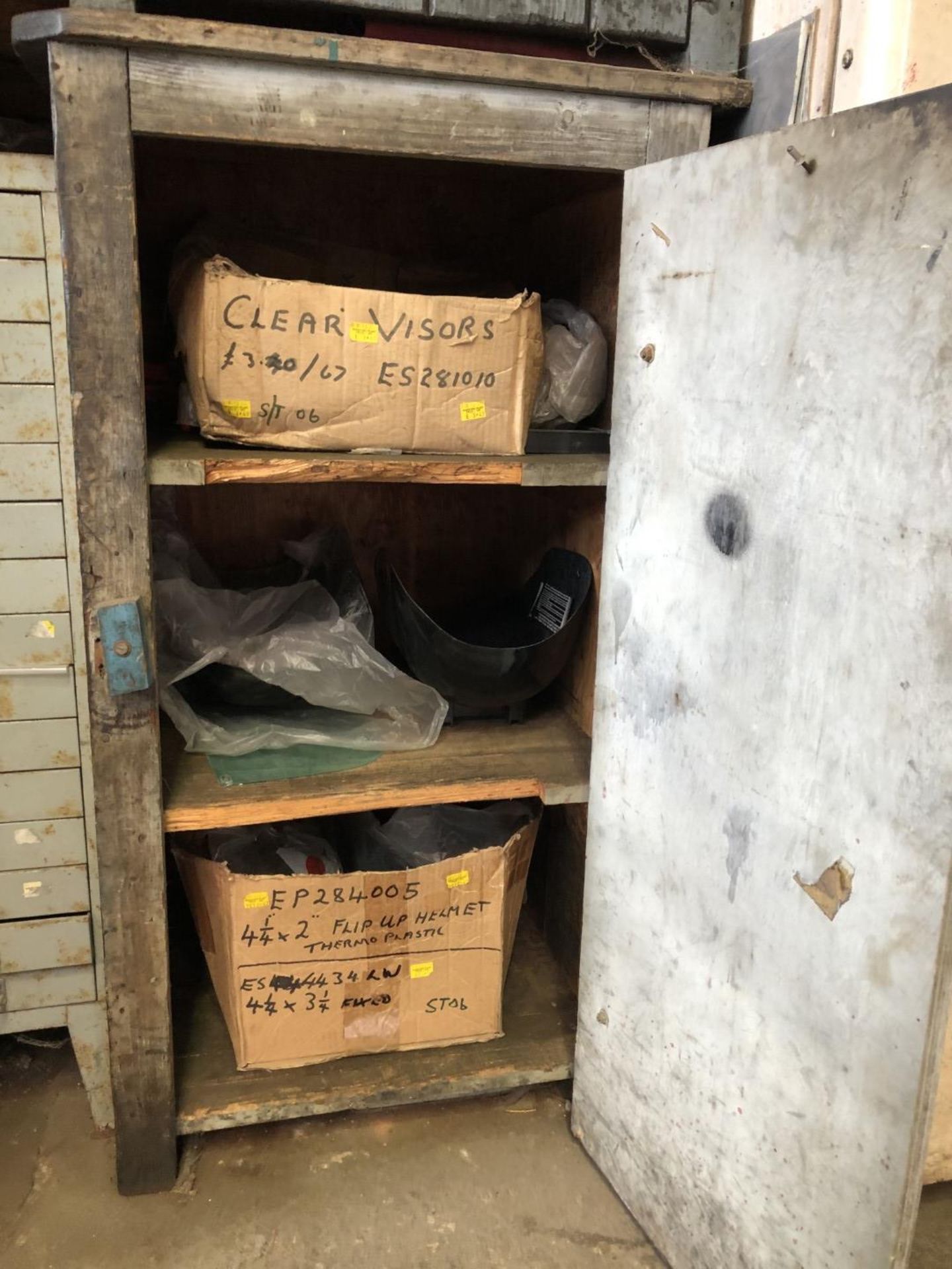 Timber grey cabinet and contents of welding visors & helmets