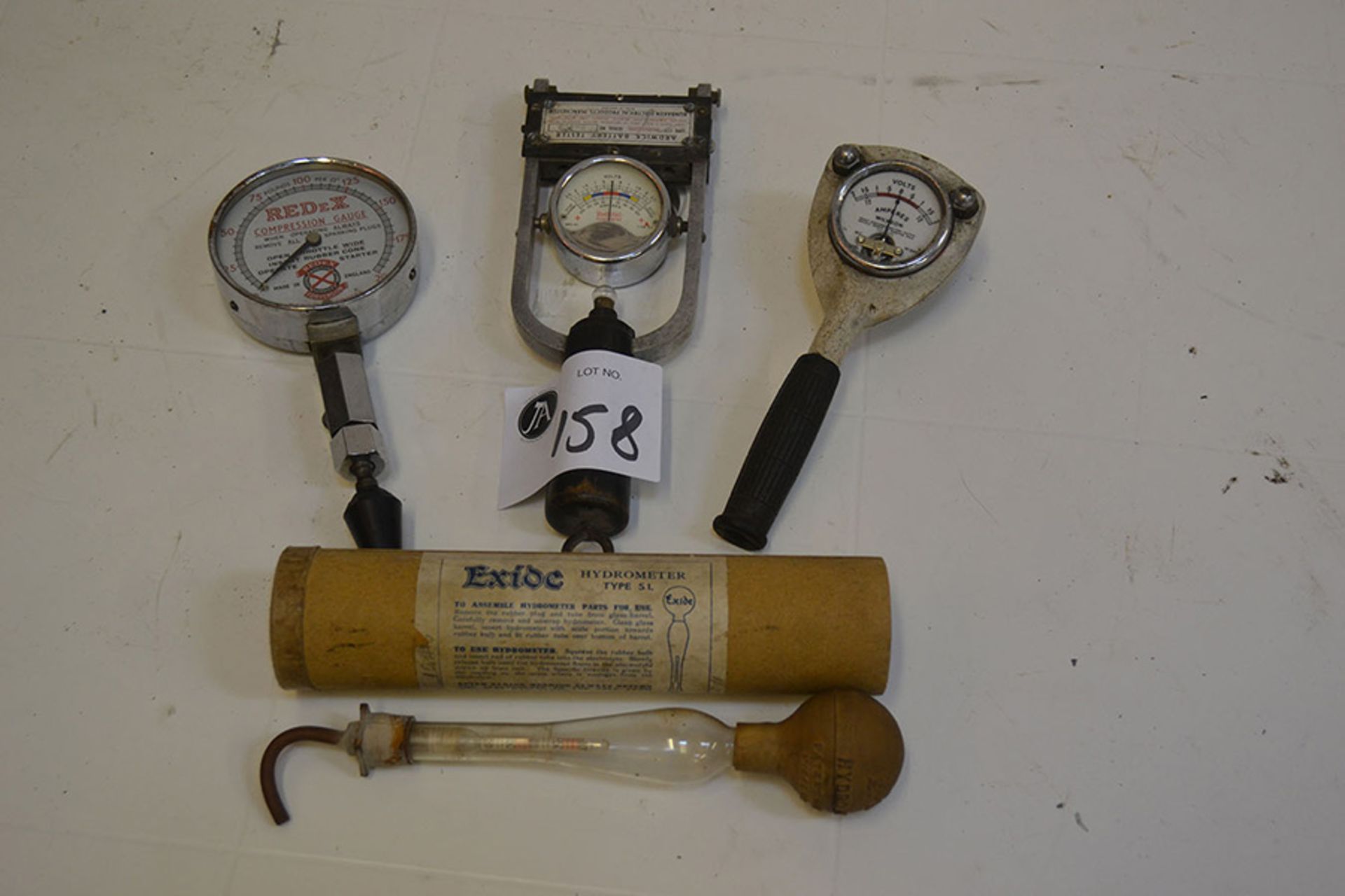 Two battery testers, hydrometer and compression gauge