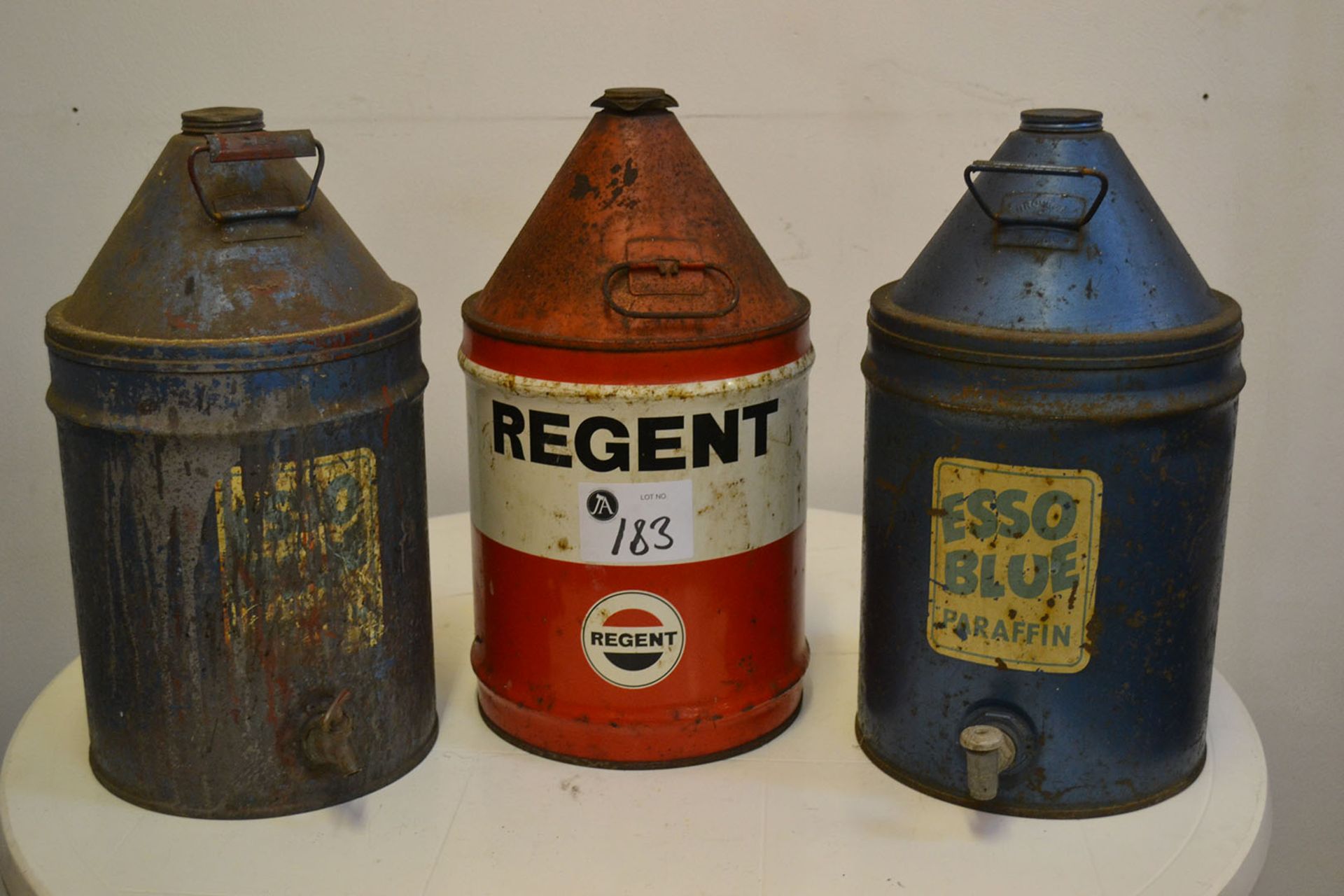 Two Esso Blue and one Regent fuel cans