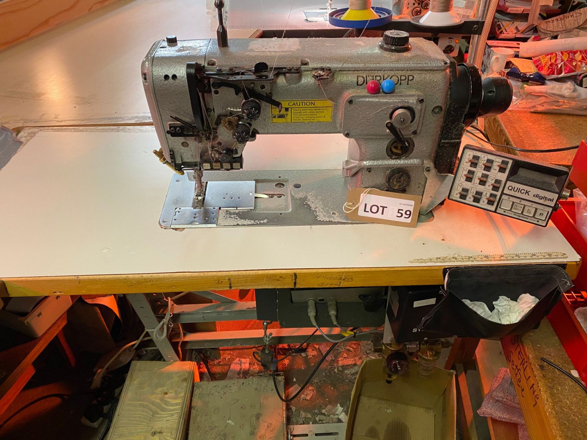 Durkopp industrial sewing machine with table, digital control, and two thread feed