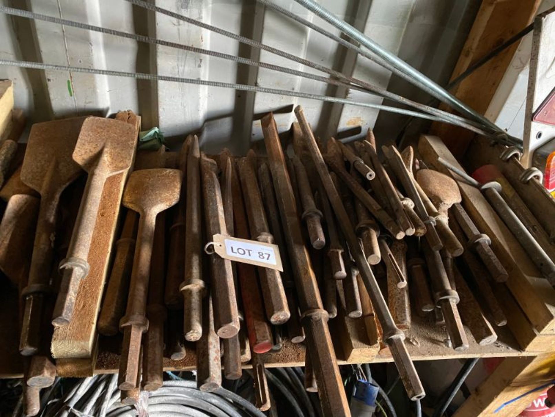 Contents of shelf comprising various steel bits, as lotted